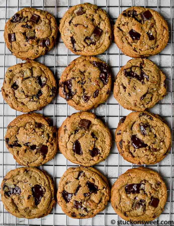 Soft chocolate chip cookies with chunks of dark chocolate on a cooling rack, perfect for sweet treat lovers.