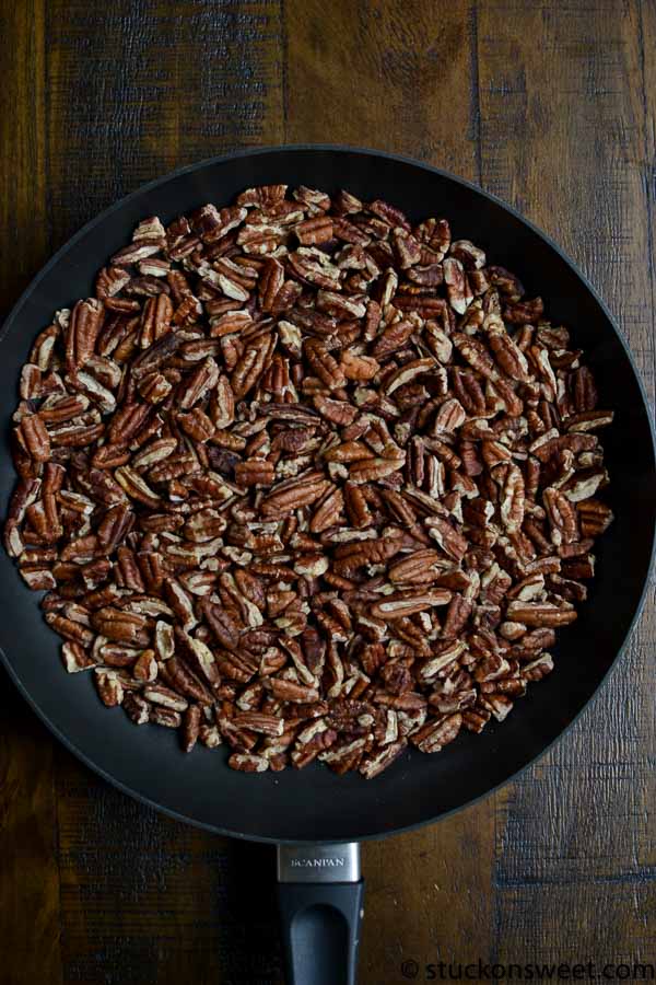 Toasted pecans in a skillet for baking or snacking.