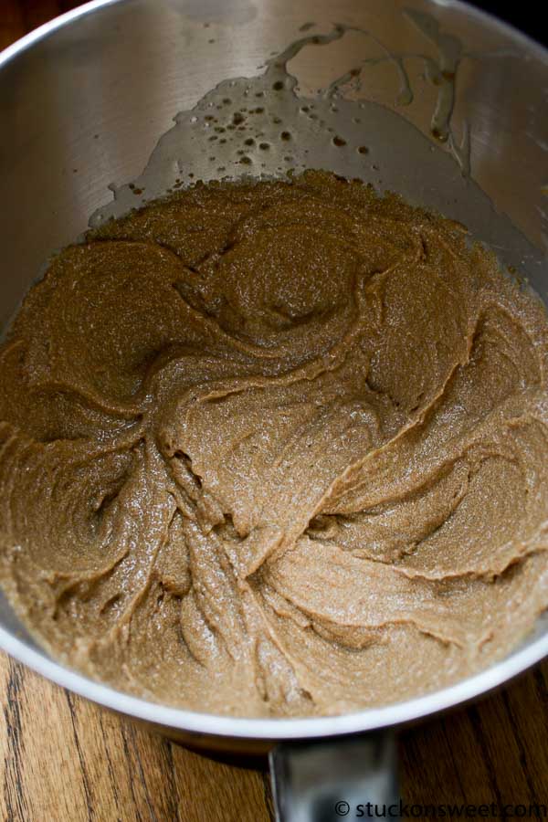 Creamy caramel frosting in a stainless steel mixing bowl, perfect for baking cupcakes and cakes.