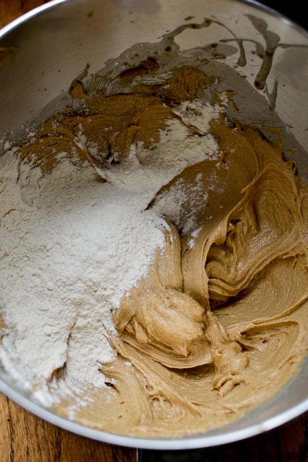 Creamy cookie dough mixture with flour and cinnamon in a stainless steel bowl, ready for baking or dessert preparation. Perfect for homemade sweet treats and desserts.