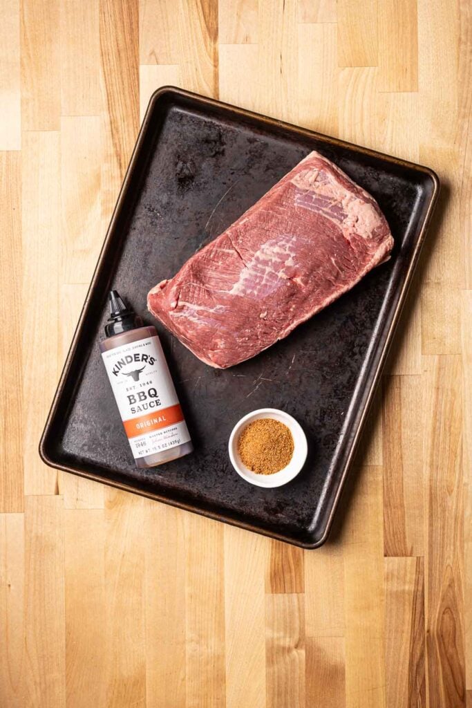 Juicy, smoked brisket with a caramelized bark and rich barbecue sauce on a wooden cutting board, perfect for barbecue lovers and meat enthusiasts.