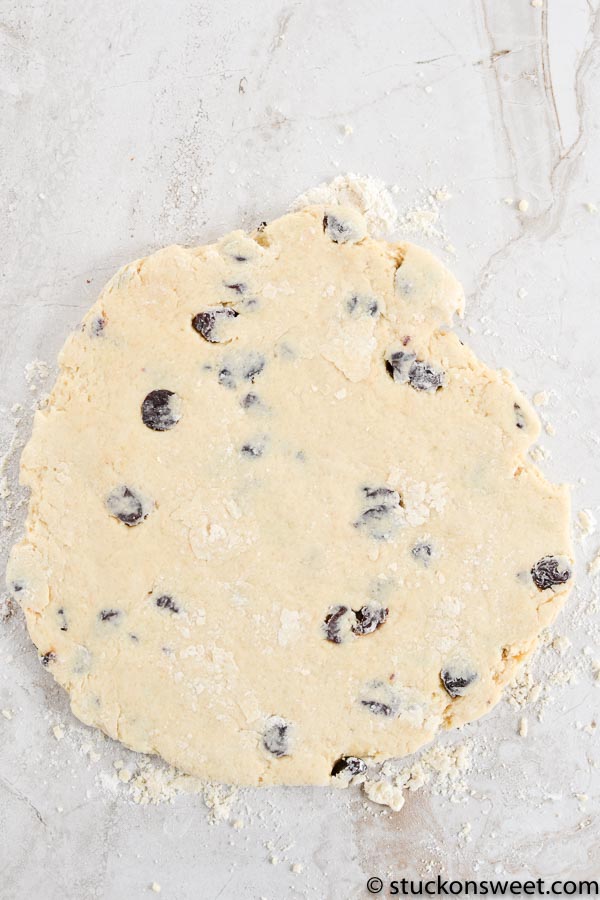 Buttery cookie dough with chocolate chips on a white marble surface, ready for baking, perfect for homemade cookie recipes.