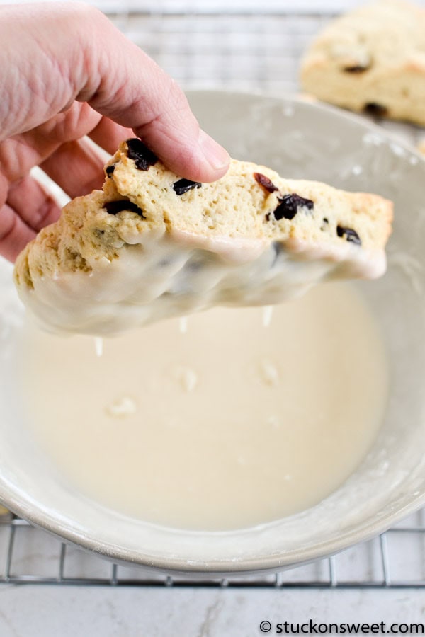 Delicious chocolate chip cookie being dipped into creamy milk for a classic dessert experience.