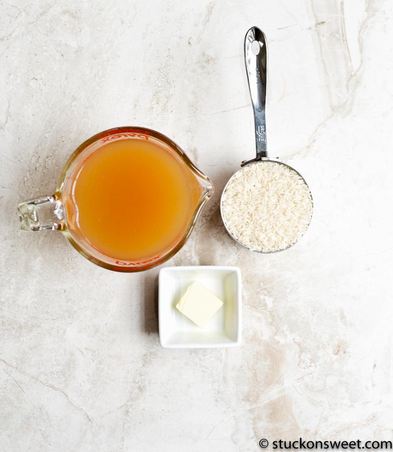Sweetened condensed milk, butter, rice, and vanilla extract for homemade rice pudding recipe.
