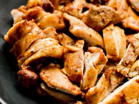 Juicy roasted chicken pieces on black plate, close-up, flavorful and crispy skin, perfect for dinner, delicious homemade protein-rich meal, Stuck On Sweet.