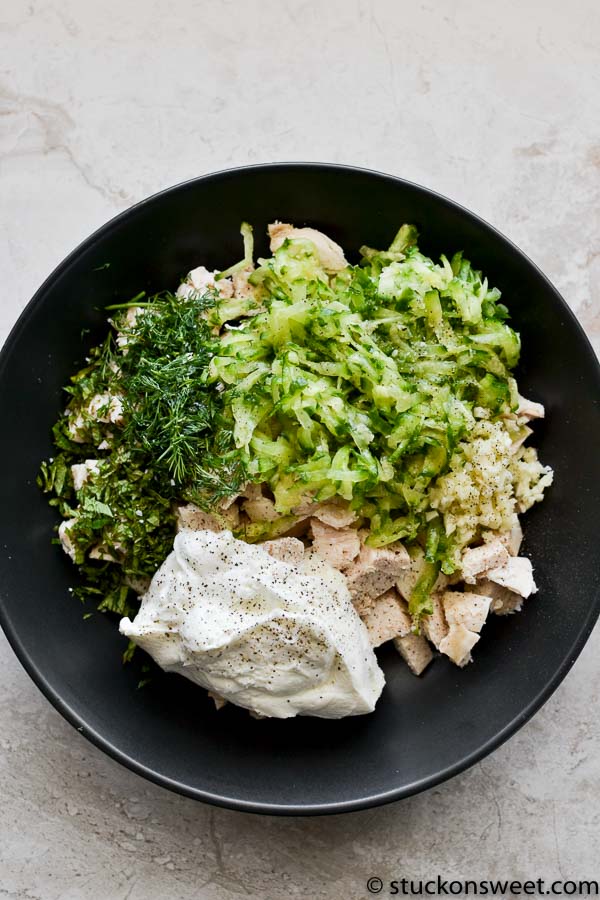 Tzatziki Chicken Salad ingredients in black bowl