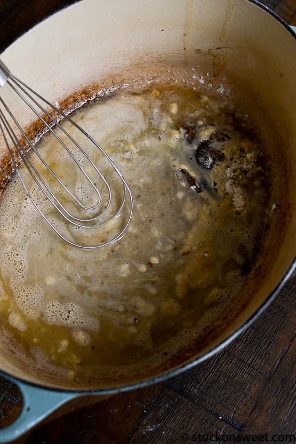 Creamy caramel sauce being prepared in a cooking pot with a whisk, ideal for dessert recipes, caramel candies, or ice cream toppings. Perfect kitchen step for sweet recipes.