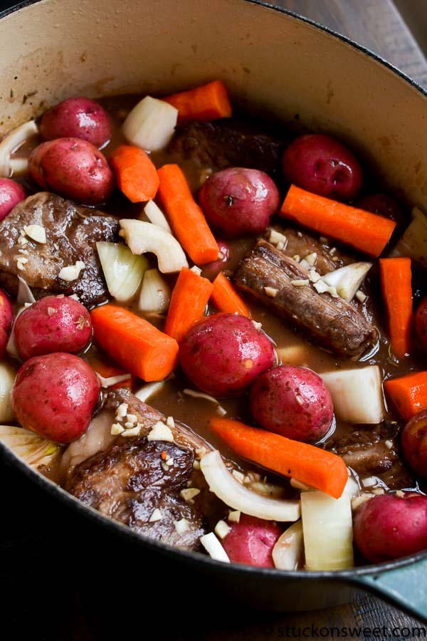 Tender beef stew with baby potatoes, carrots, and onions cooking in a savory broth. Perfect comfort food recipe for hearty meals and family dinners.