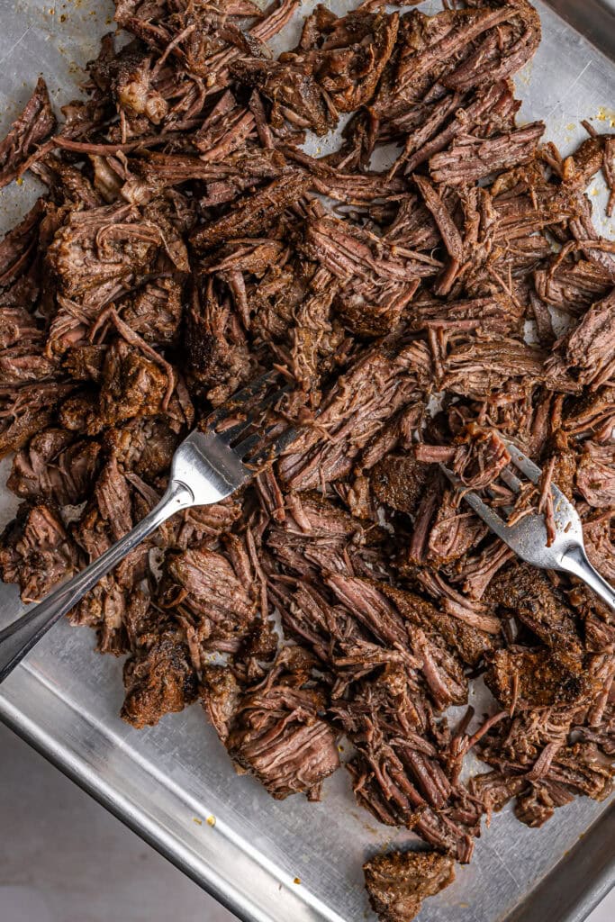 Tender shredded beef brisket cooked to perfection, ideal for sandwiches or main dishes. Perfectly seasoned and slow-cooked for rich, savory flavor in every bite. Great for family dinners or gatherings.