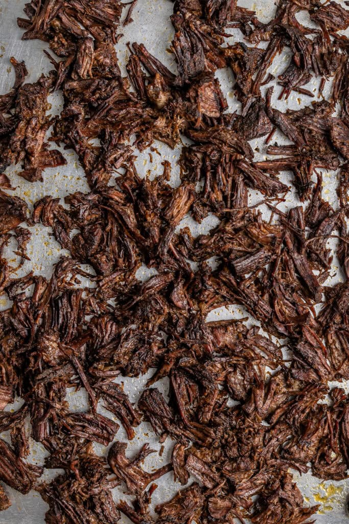 Tender, shredded beef cooked in rich barbecue sauce, perfect for sandwiches, tacos, or meals, ready to enjoy or repurpose in flavorful recipes.
