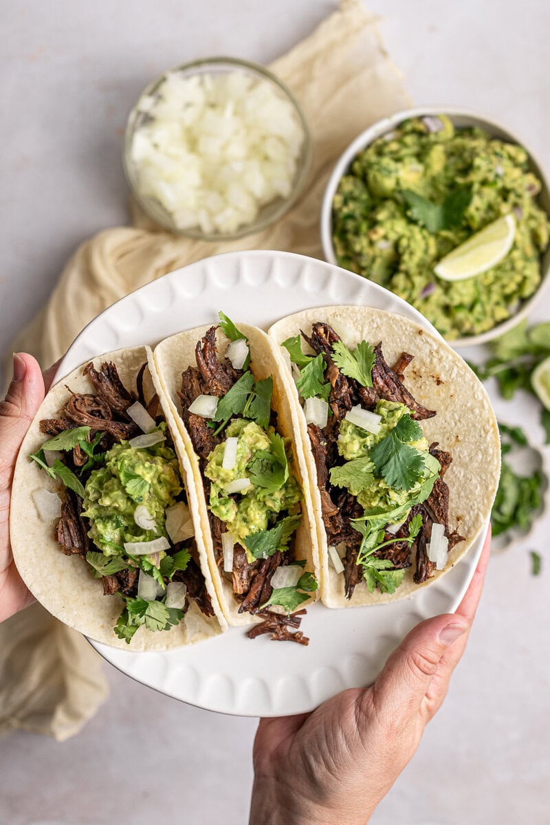 Slow Cooker Beef Tacos with Fresh Ingredients and Guacamole.