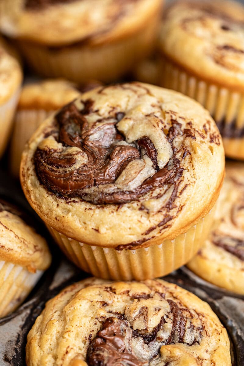 Decadent chocolate marble muffins with swirls of rich chocolate in moist, fluffy cake. Perfect for breakfast or dessert, these homemade muffins are a sweet treat from Stuck On Sweet.