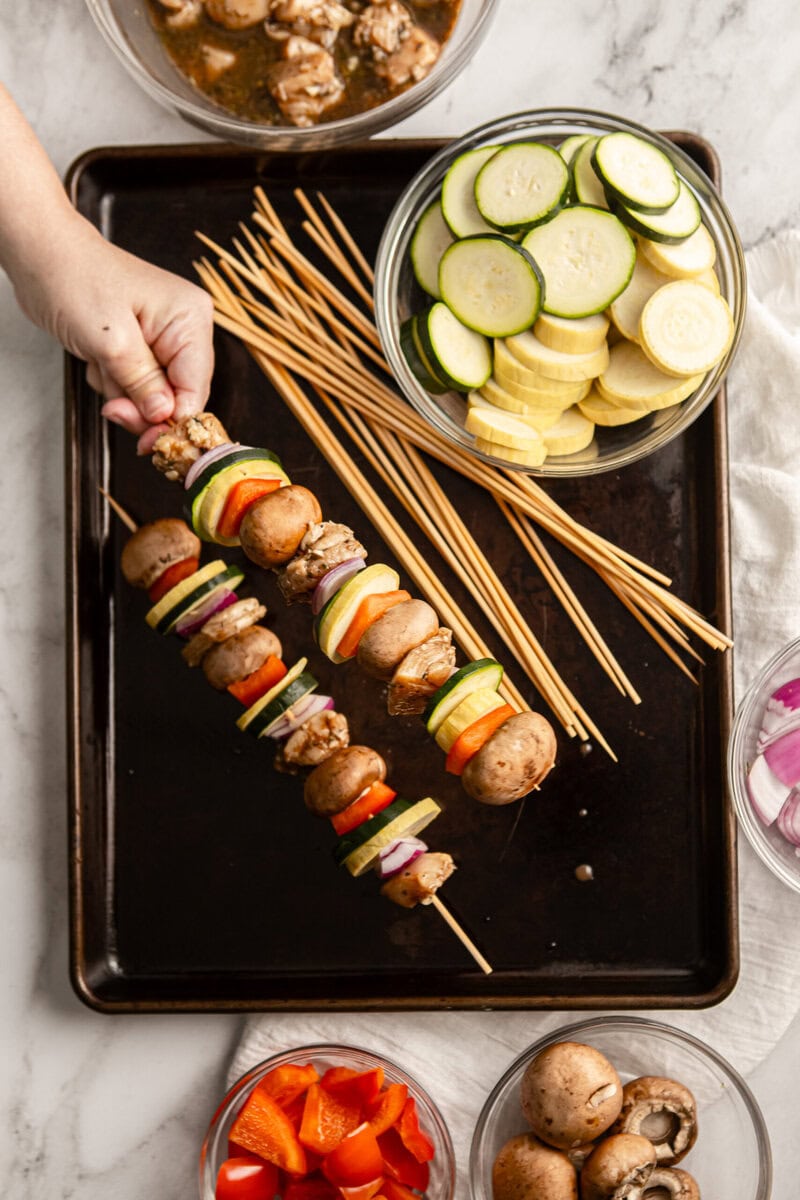 Tokyo Fresh vegetable skewers with mushrooms, zucchini, yellow squash, red onion, and bell peppers, perfect for summer grilling and healthy snacking.