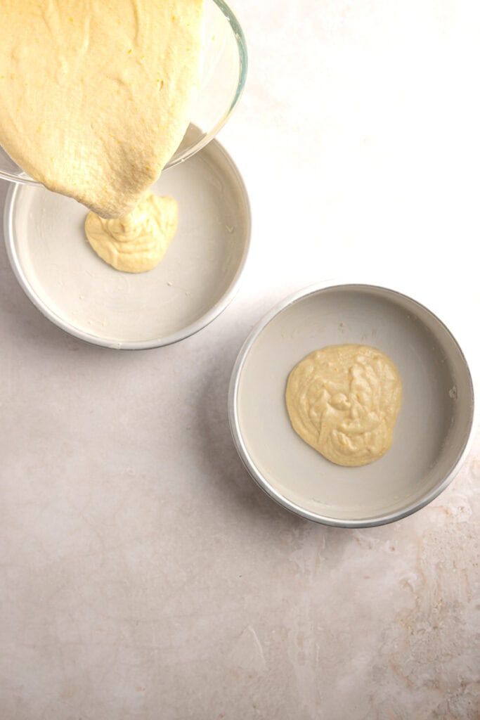 Creamy cake batter pouring into baking molds for delicious homemade desserts.