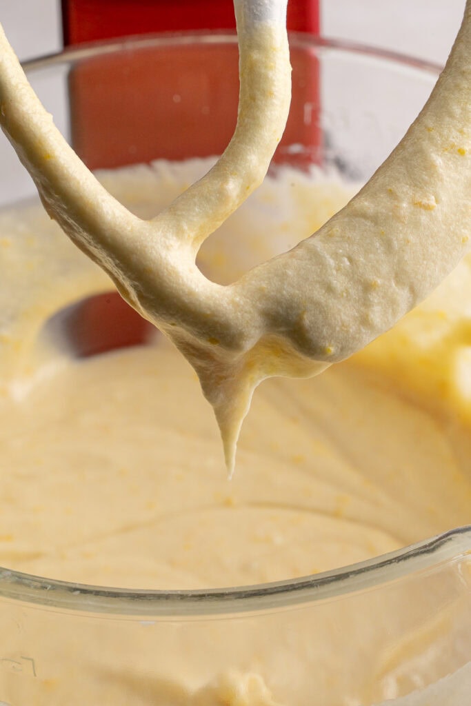 Creamy vanilla cake batter on a stand mixer paddle, ready for baking, showcasing smooth texture and rich flavor, ideal for cake making, baking recipes, and dessert baking.