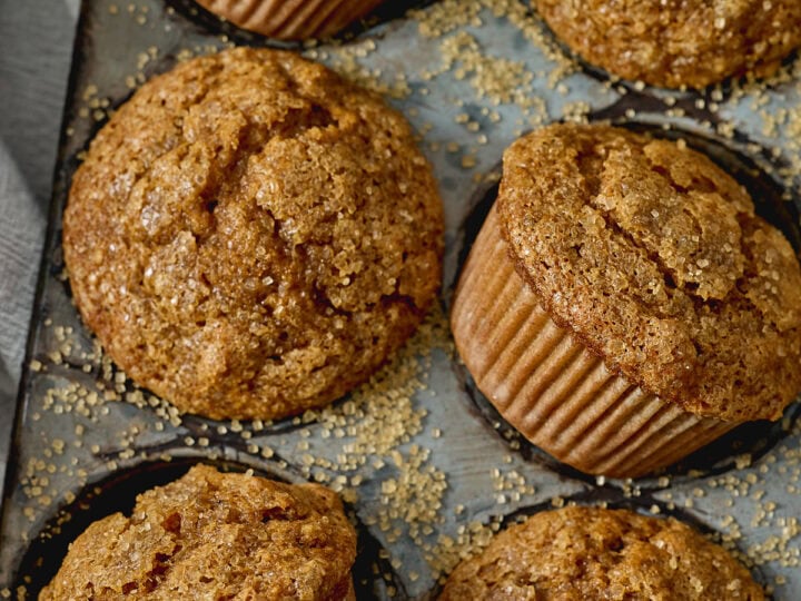 Freshly baked cinnamon sugar muffins with crumbly topping from Stuck On Sweet. Perfect for breakfast, snack, or dessert, these moist muffins are packed with warm cinnamon flavor.