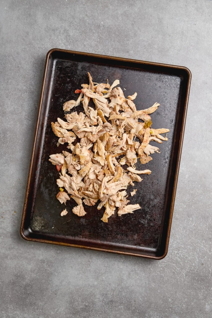 shredded chicken thighs on a sheet pan