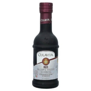 Colavita aged balsamic vinegar of Modena in glass bottle, Italian culinary ingredient for salads and cooking.