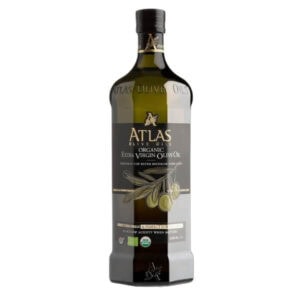 Rich organic extra virgin olive oil in dark glass bottle, ideal for healthy cooking and dressings.