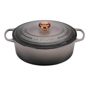 Le Creuset cast iron Dutch oven with glass lid for versatile cooking and baking.
