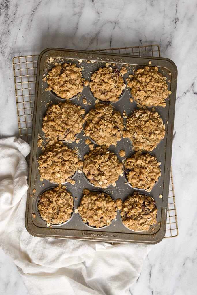 Oatmeal blackberry crumble cookies on a baking tray. Fresh baked dessert, perfect for breakfast or snack. Image showcases delicious homemade crumbly blueberry treats.