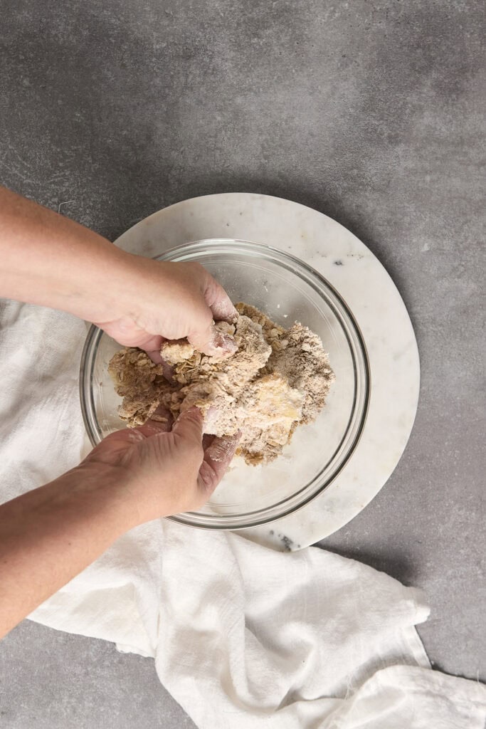 Hand mixing cookie dough in glass bowl for cookies and desserts, food preparation, sweet treats, baking ingredients, kitchen baking, dessert recipe, culinary cooking.