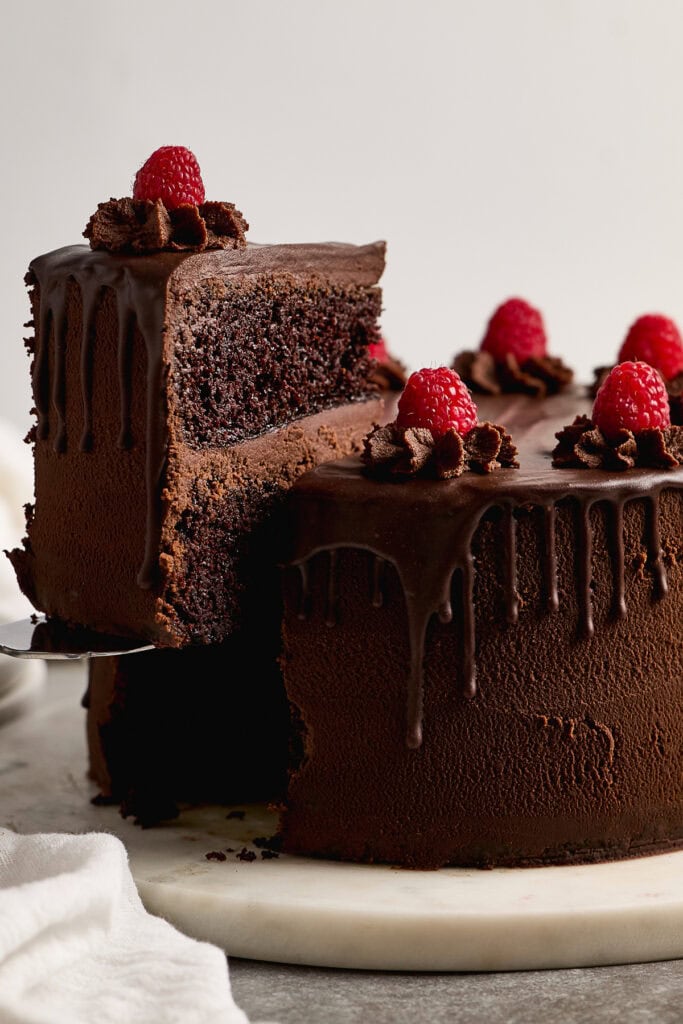 Rich chocolate ganache cake with raspberry topping and chocolate ganache drip, perfect for birthdays or special occasions. Made with premium ingredients for an indulgent dessert experience.