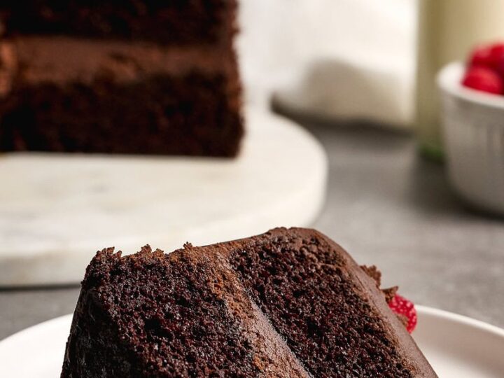 Rich chocolate ganache cake slice with moist layers and dark chocolate ganache frosting, perfect for dessert or special occasions. Flavorful and delightful, it appeals to cake lovers and dessert enthusiasts.