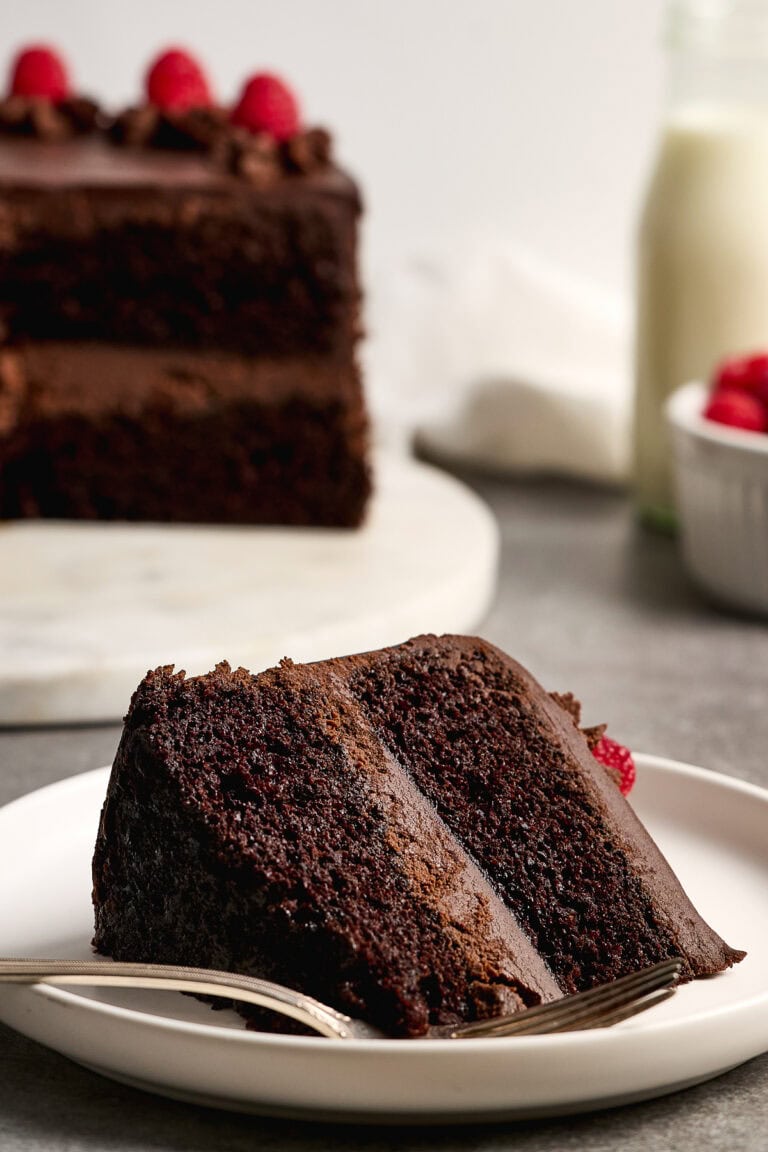Rich chocolate ganache cake slice with moist layers and dark chocolate ganache frosting, perfect for dessert or special occasions. Flavorful and delightful, it appeals to cake lovers and dessert enthusiasts.