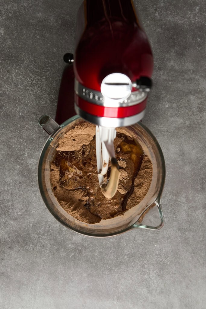 Creamy chocolate cake batter with rich cocoa powder, mixed with a stand mixer, ready to bake, perfect for indulgent desserts and special occasions.
