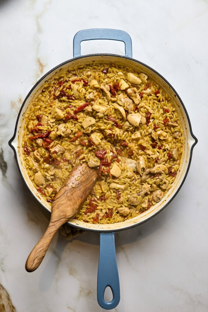 Delicious one-pan chicken and orzo pasta dish with sun-dried tomatoes, herbs, and tender chicken pieces cooked to perfection, served in a light creamy sauce for a hearty, flavorful meal.
