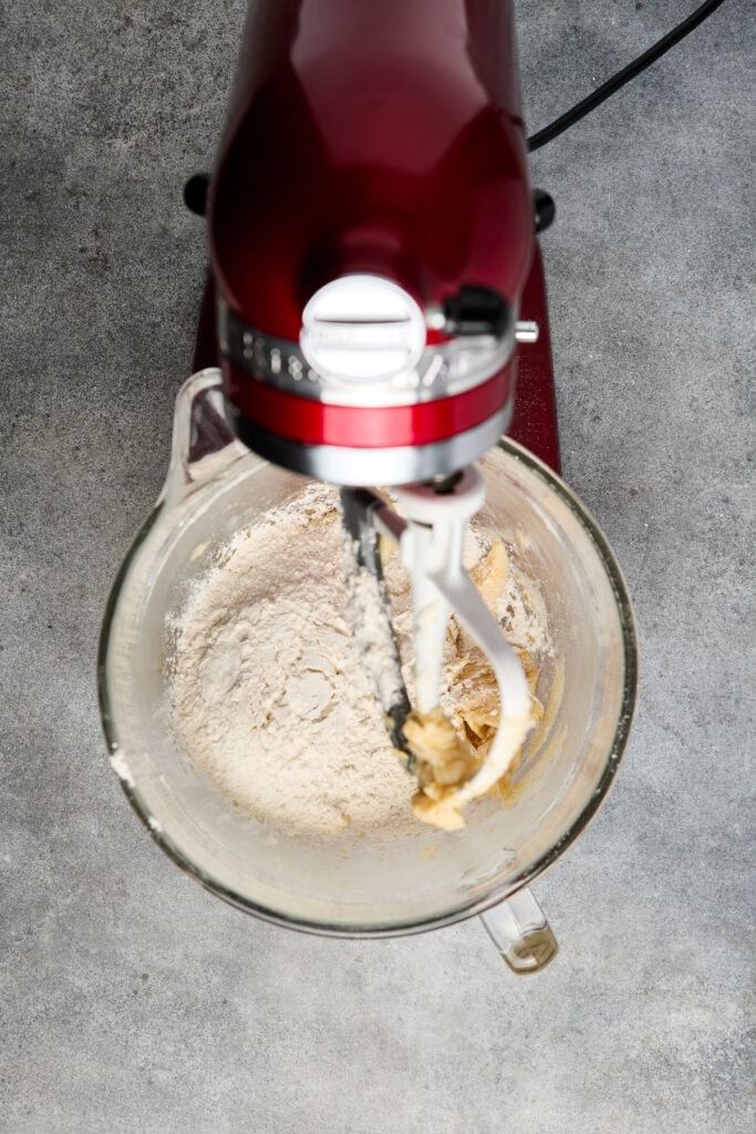 Mixer blending flour and butter for baking at Stuck On Sweet.