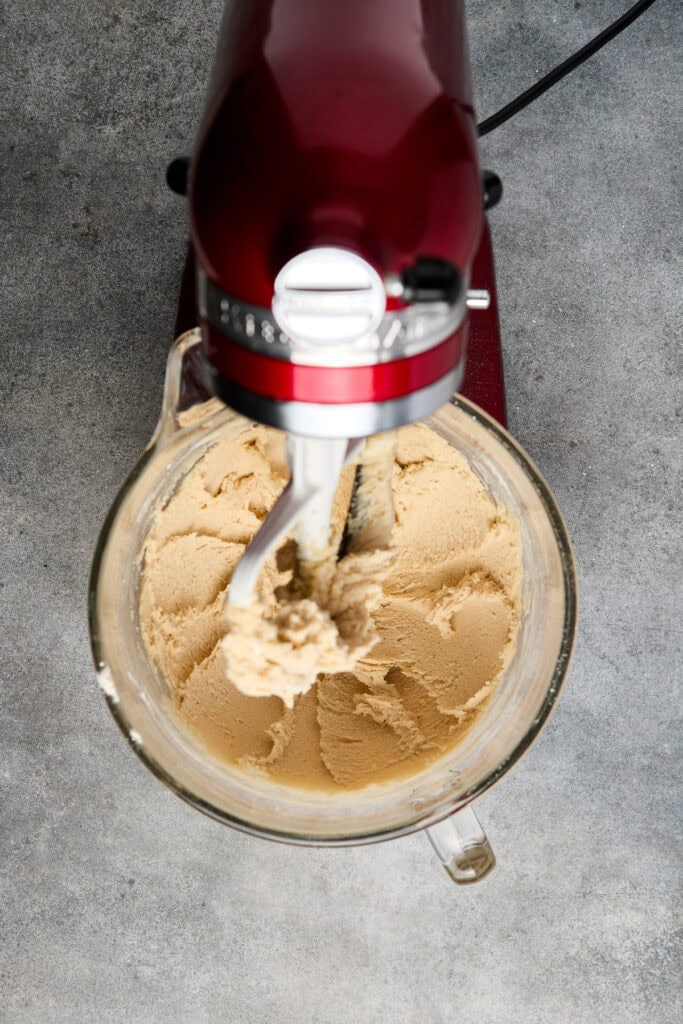 Delicious vanilla ice cream being prepared with a stand mixer, showcasing smooth, creamy texture perfect for dessert lovers.