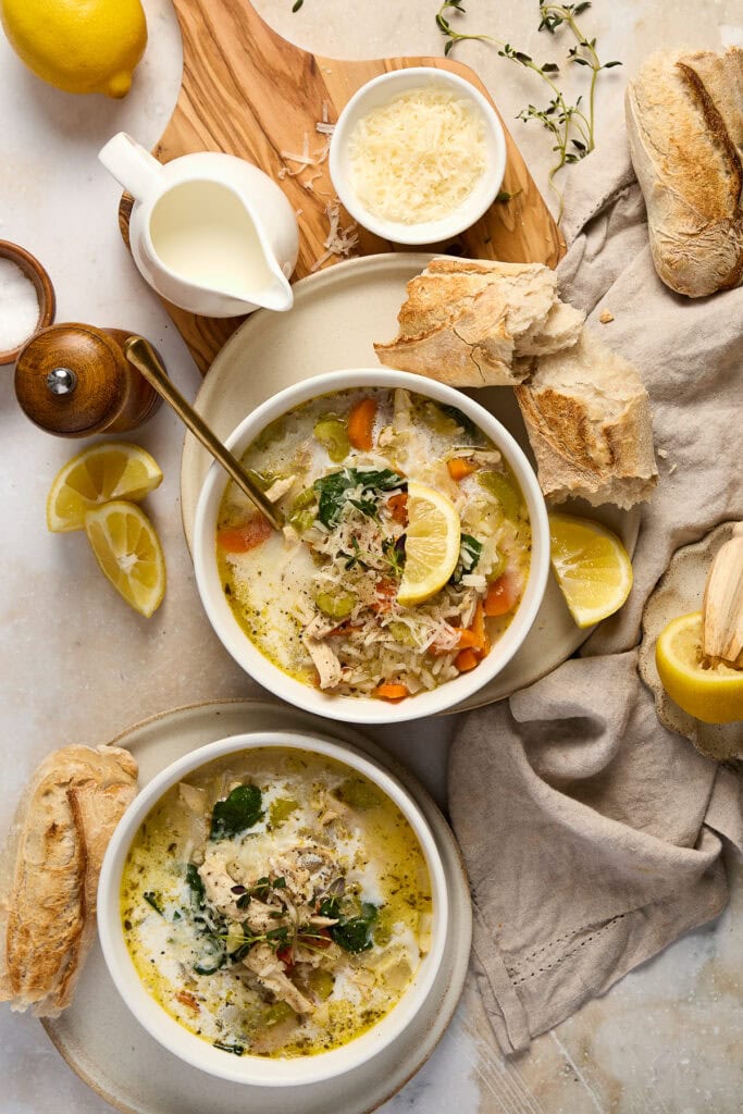 Delicious Lemon Chicken Rice Soup with fresh lemon slices and herbs, served with crusty bread. Perfect comfort food for cold days, highlighting bright citrus flavors and tender chicken.