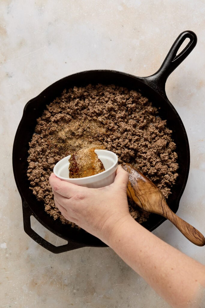 Delicious homemade crumble topping being prepared in a cast iron skillet, perfect for desserts like apple crumble or fruit crisps.