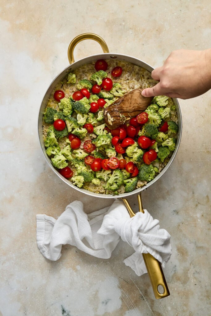 Healthy vegetable stir-fry with broccoli and cherry tomatoes in a skillet.