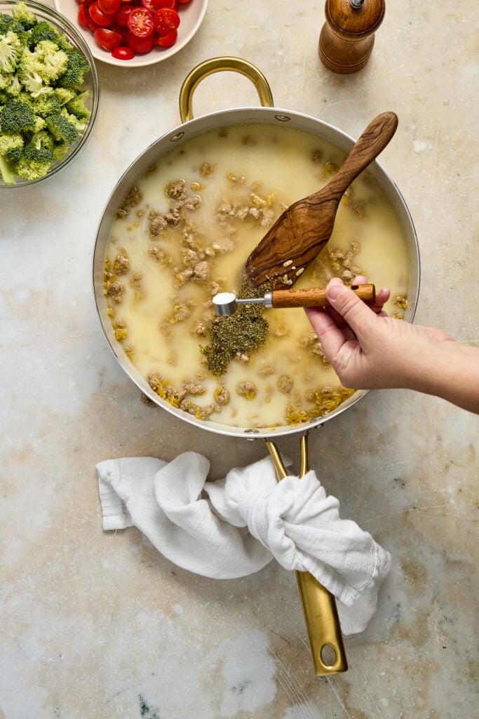 Delicious homemade lentil soup cooking in a skillet, featuring a creamy texture with vegetables and herbs, perfect for healthy meals.