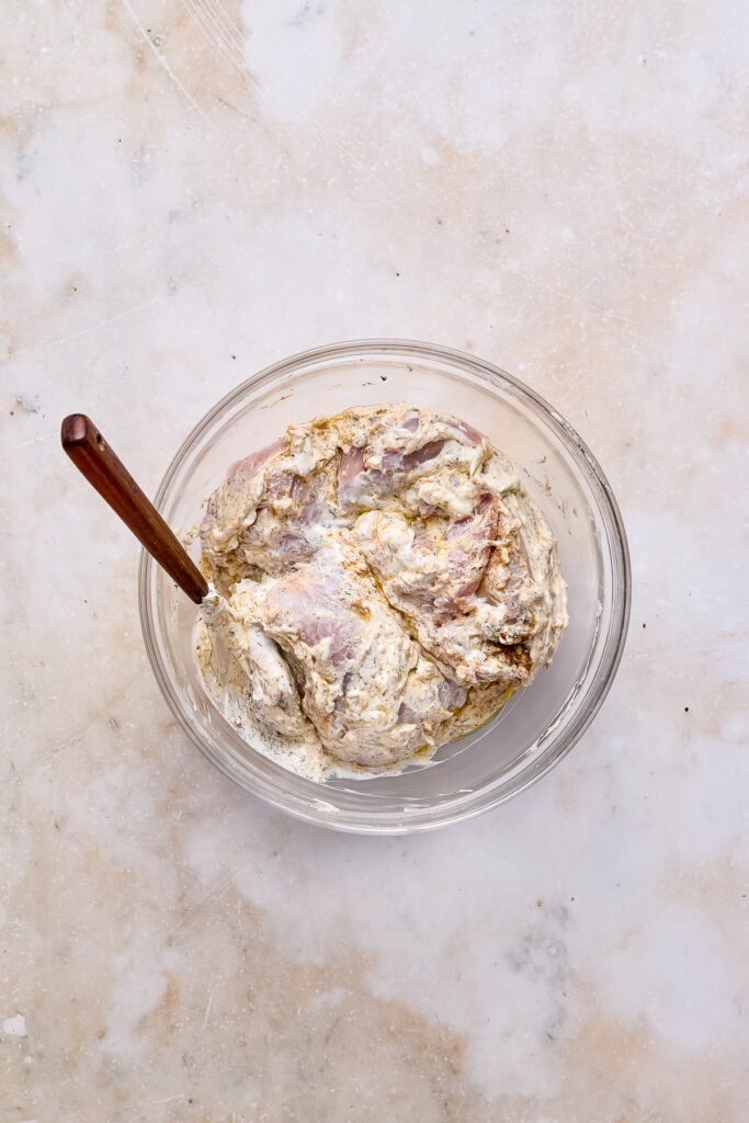 yogurt marinated greek chicken in a bowl