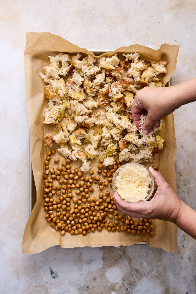 Fresh homemade croutons and roasted chickpeas on parchment paper, ready for salad topping or snacking.