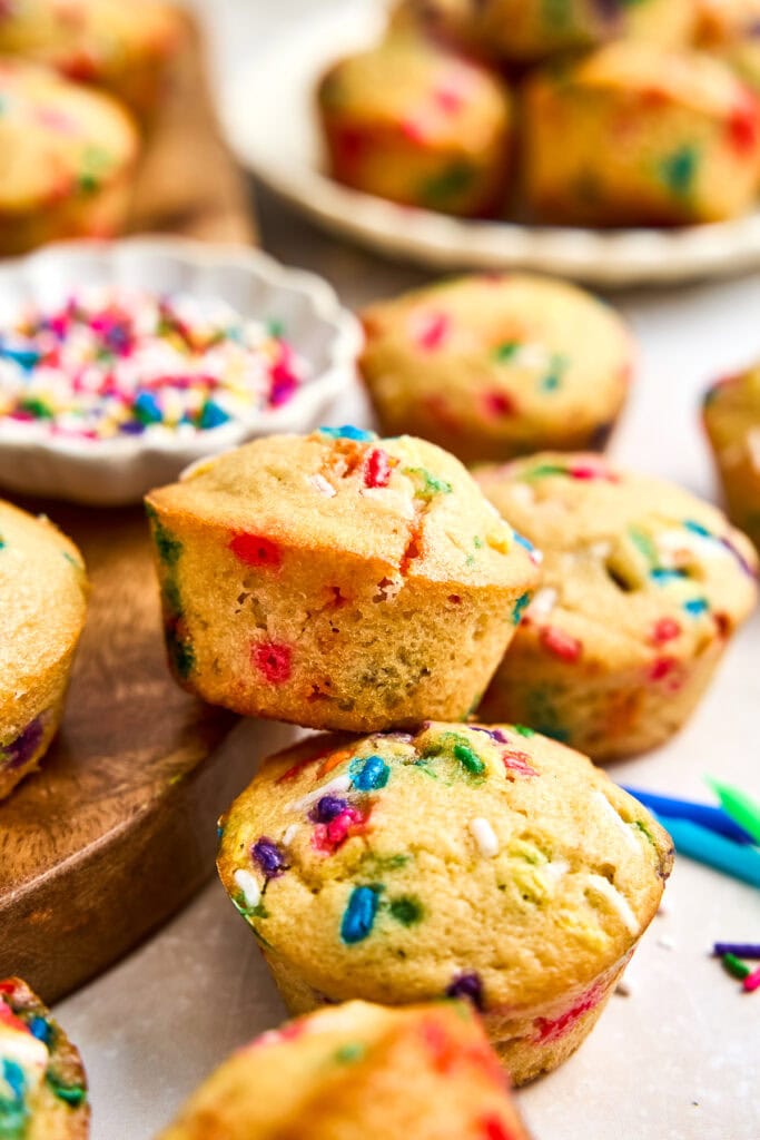 Close-up of freshly baked mini muffins with colorful sprinkles on top, perfect for celebrations and parties.